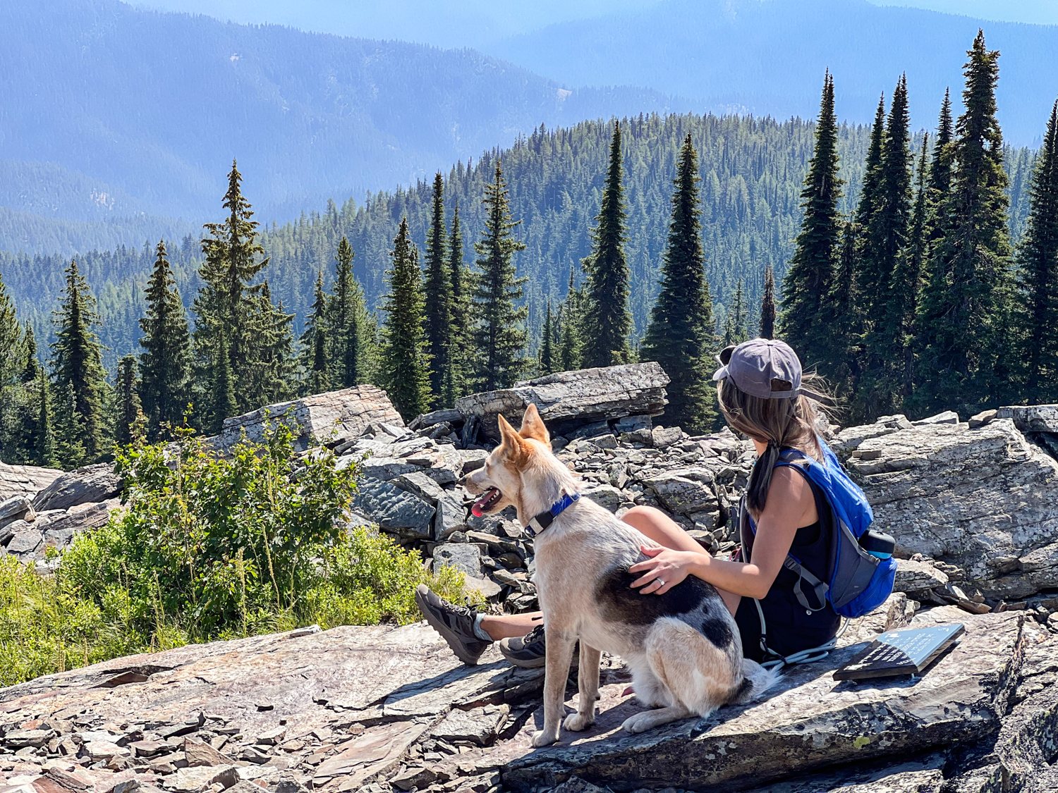 Diana and Toby on a rocky summit above an alpine lake